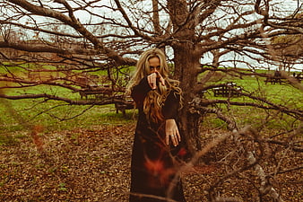Woman Pointing at Camera in Autumn Park