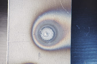 Close-up of metal weld with heat discoloration texture