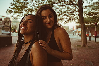 Two Happy Female Friends Laughing on Urban Street