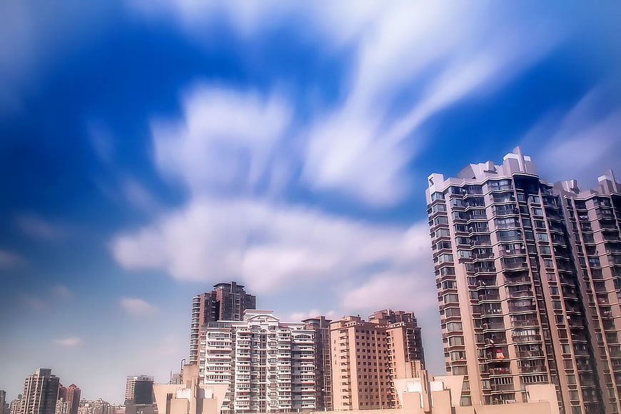 Urban Cityscape with Streaking Clouds and High-Rise Buildings