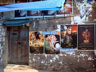 Weathered Bollywood Movie Posters On Old Urban Street Wall
