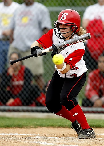Female Softball Player Swinging Bat at Ball