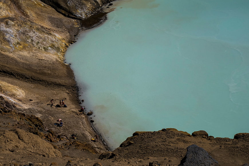 Aerial View of Turquoise Geothermal Lake with Hikers