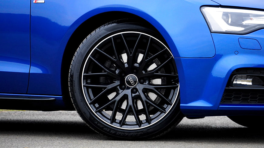 Close-up of Blue Audi Wheel and Headlight