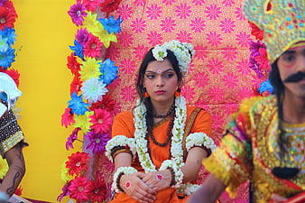 Woman in traditional orange attire at Indian cultural festival