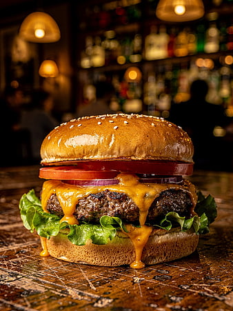 Juicy Grilled Cheeseburger on Rustic Wooden Bar Counter