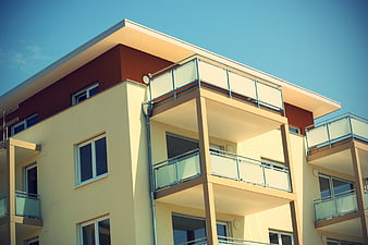 Modern Apartment Building Facade With Balconies And Clear Blue Sky