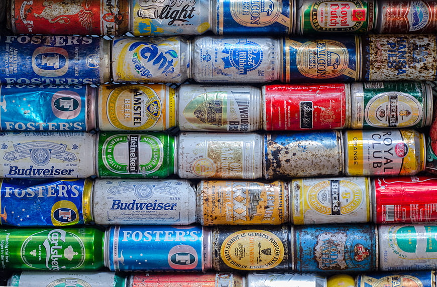 Stack of crushed and rusty vintage beer cans