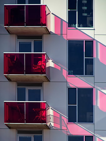 Modern Apartment Facade with Red Balconies and Shadows