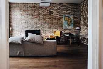 Modern Loft Living Room with Exposed Brick Wall and Yellow Chair