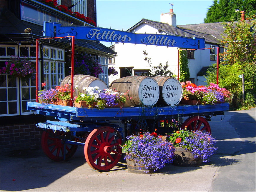 Vintage blue beer wagon with barrels and flowers