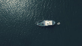 Aerial view of a luxury yacht anchored in deep blue ocean