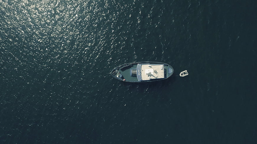 Aerial view of a luxury yacht anchored in deep blue ocean
