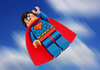 Lego Superman Minifigure Flying Against Blue Sky Background