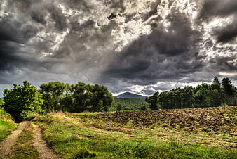 Dramatic Storm Clouds Over Rural Landscape with Dirt Path