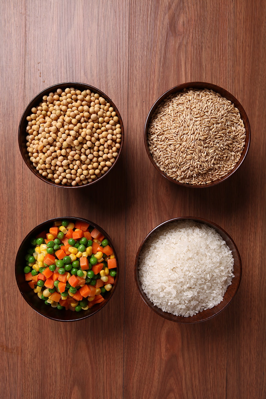 Top-Down View of Four Wooden Bowls With Grains and Vegetables
