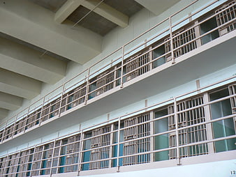 Low angle view of prison cell blocks with barred windows