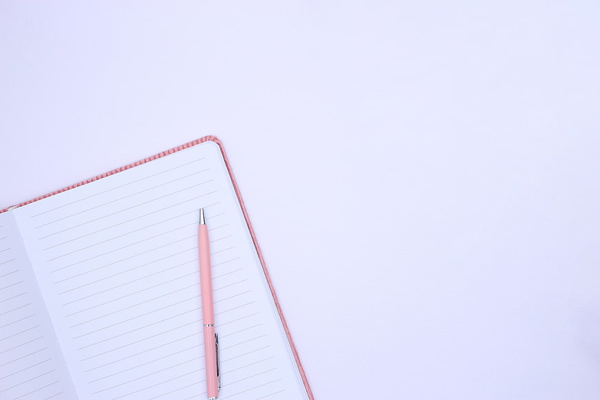 Pink Pen on Open Notebook with Blank Pages and Copy Space