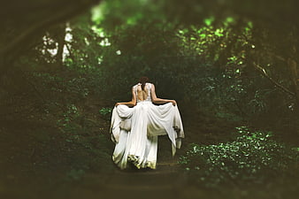 Woman in White Gown Walking Through Dark Forest