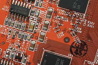 Macro shot of red circuit board with electronic components