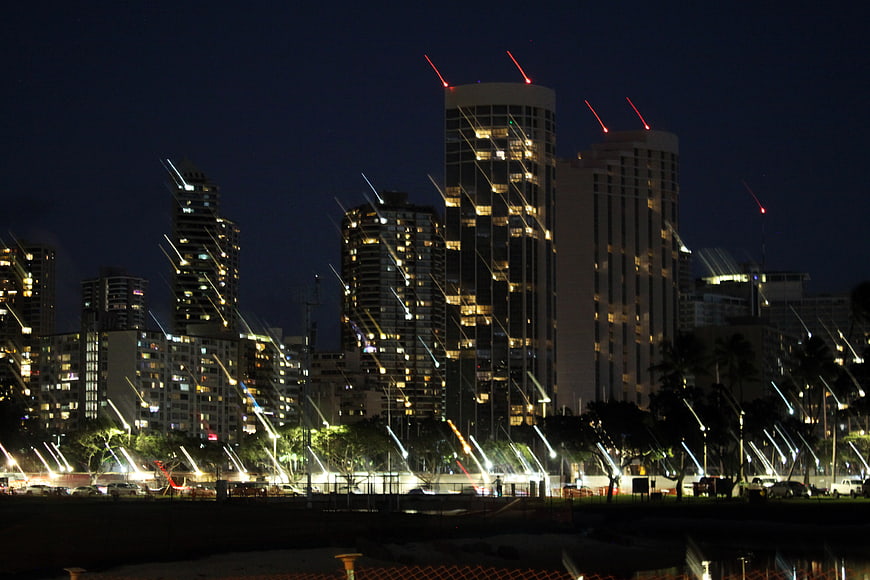 Night cityscape with light streaks and illuminated skyscrapers