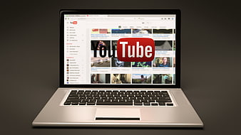 Laptop displaying YouTube homepage on screen