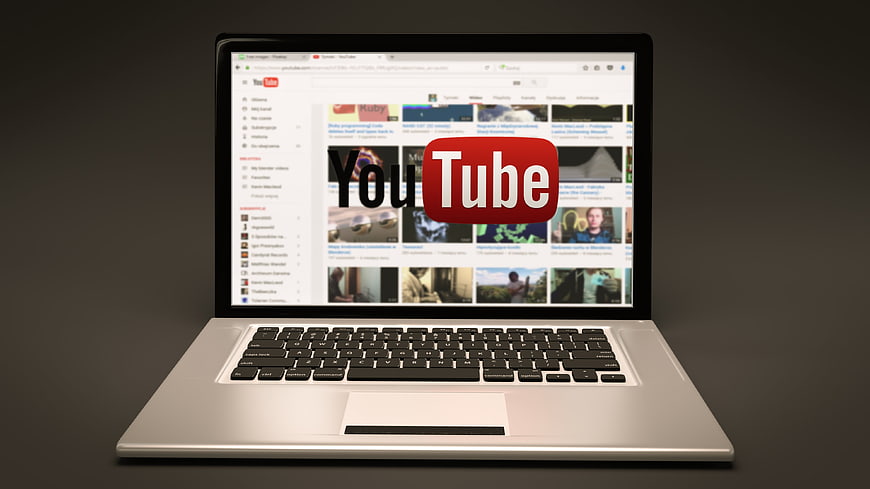 Laptop displaying YouTube homepage on screen