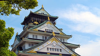 Osaka Castle Tower With Golden Ornaments And Blue Sky