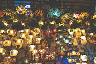 Colorful Turkish mosaic lamps hanging in a market shop