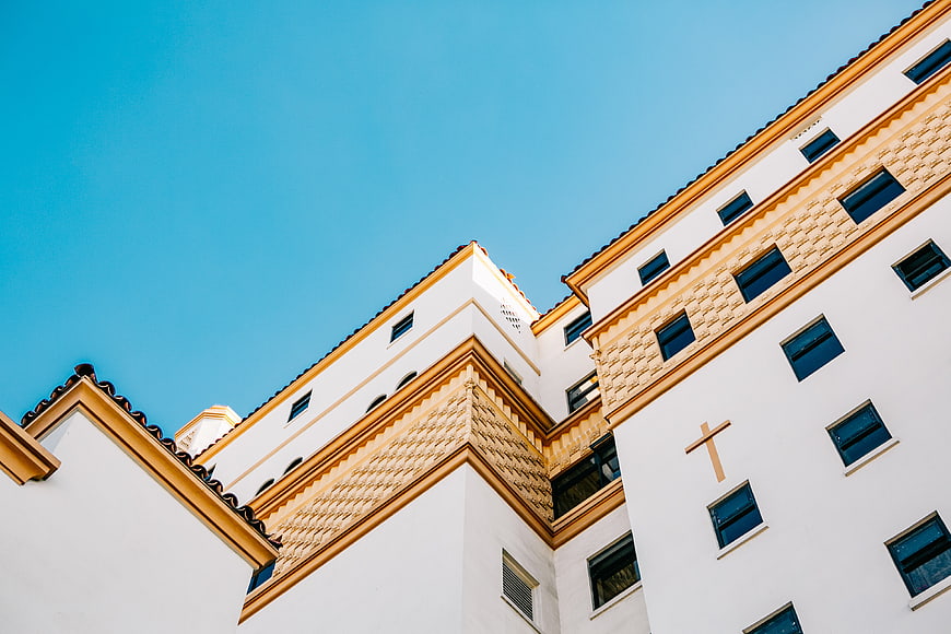 Low angle view of white church architecture with blue sky