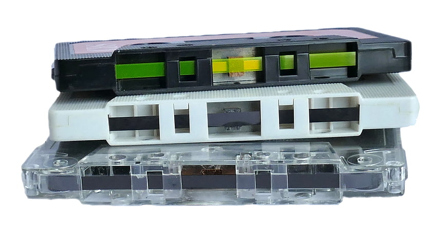 Stack of vintage audio cassette tapes on white background