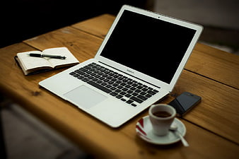 White Laptop, Coffee, and Notebook on Wooden Table
