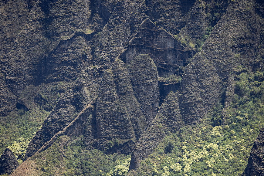 Steep Rocky Mountain Ridge with Lush Green Vegetation