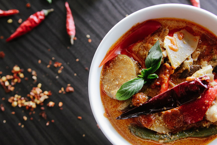 Spicy Thai Curry with Crab and Basil in White Bowl