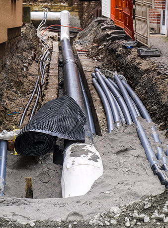 Underground Utility Trench With Pipes And Geotextile Roll