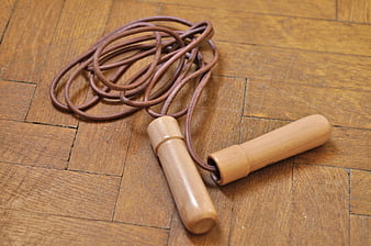 Vintage Leather Skipping Rope With Wooden Handles On Parquet Floor