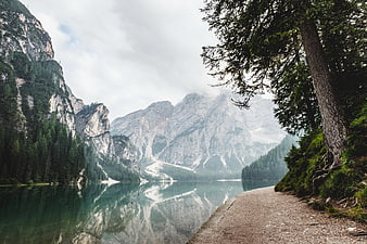 Serene Mountain Lake with Forest Path and Reflections