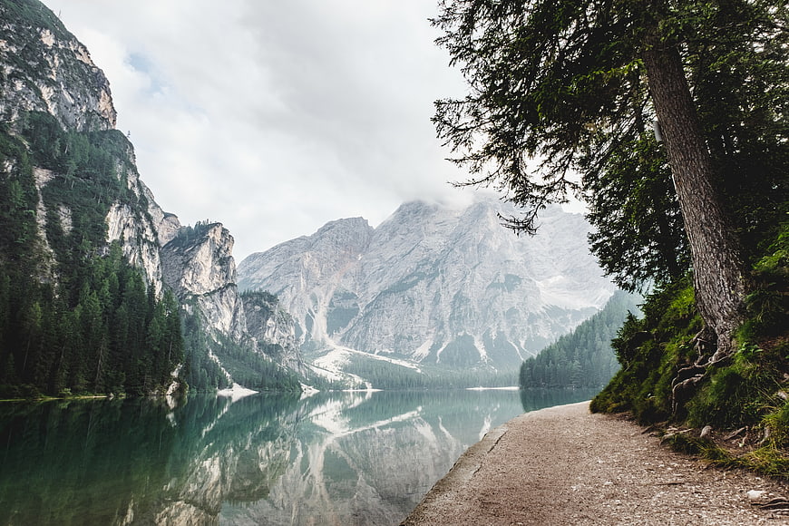 Serene Mountain Lake with Forest Path and Reflections