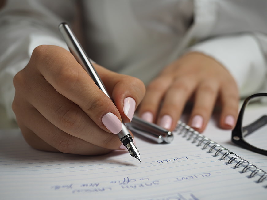 Woman Writing in Notebook with Fountain Pen