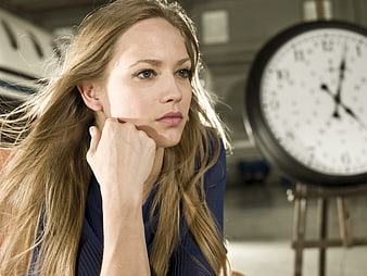 Blonde Woman Pensive Portrait With Windblown Hair And Clock