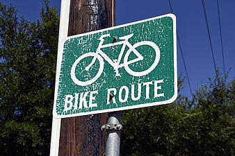 Weathered Green Bike Route Sign On Wooden Pole