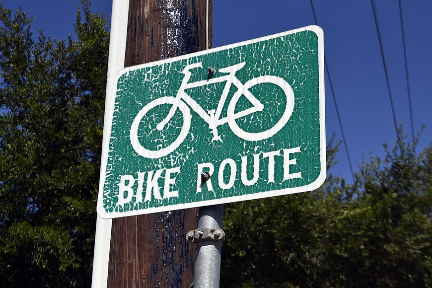 Weathered Green Bike Route Sign On Wooden Pole