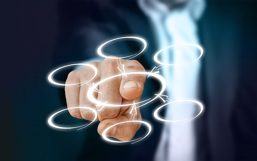 Businessman hand touching glowing digital network rings