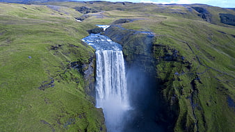 Aerial View of Majestic Waterfall in Green Icelandic Highlands