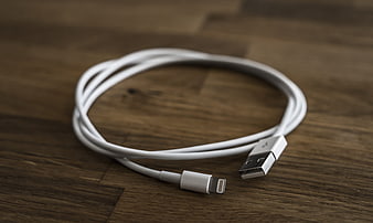 White Lightning USB Cable on Wooden Surface
