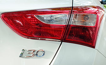 Close-up of Hyundai i30 rear taillight and badge on white car