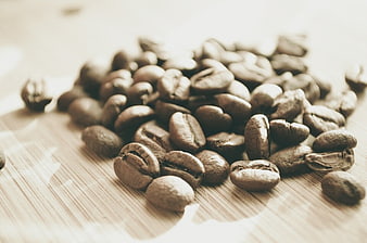 Roasted coffee beans on wooden surface