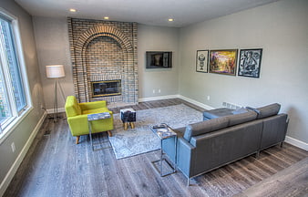 Modern living room with brick fireplace and green armchair