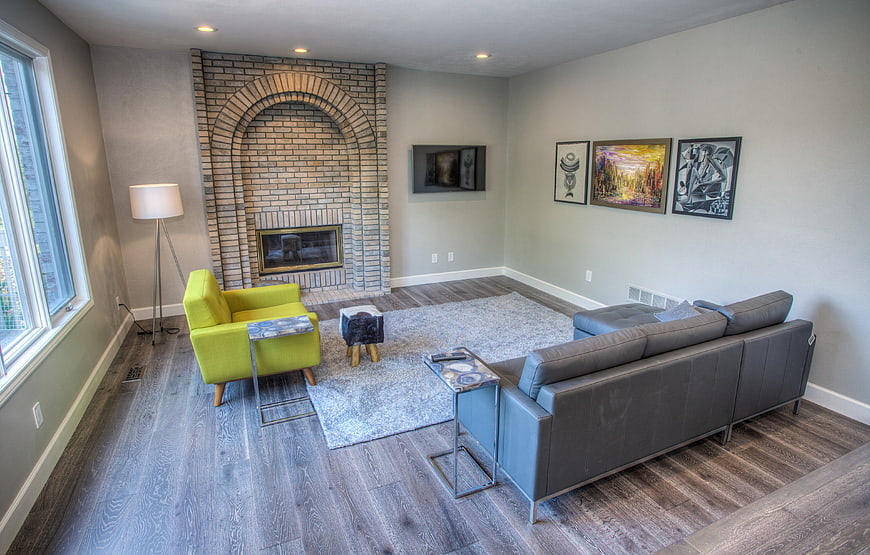 Modern living room with brick fireplace and green armchair