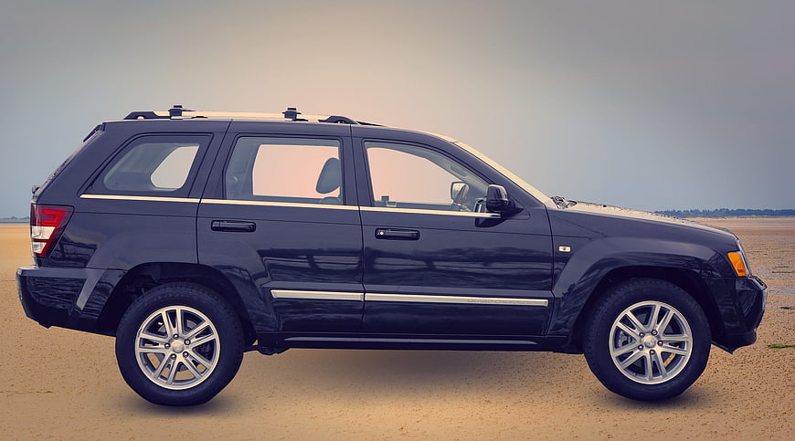 Side Profile of Black SUV on Sandy Beach